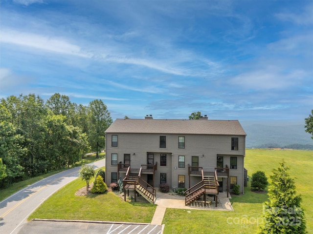 2881 White Oak Mountain Rd Unit D5, Columbus, NC 28722 - rear view of house with stairway, a yard, uncovered parking, a chimney, and a deck