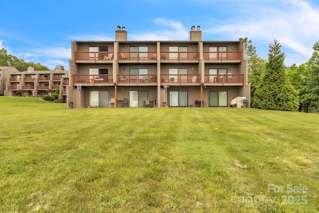 2881 White Oak Mountain Rd Unit D5, Columbus, NC 28722 - back of property with a yard, a chimney, a balcony, and a wooden deck