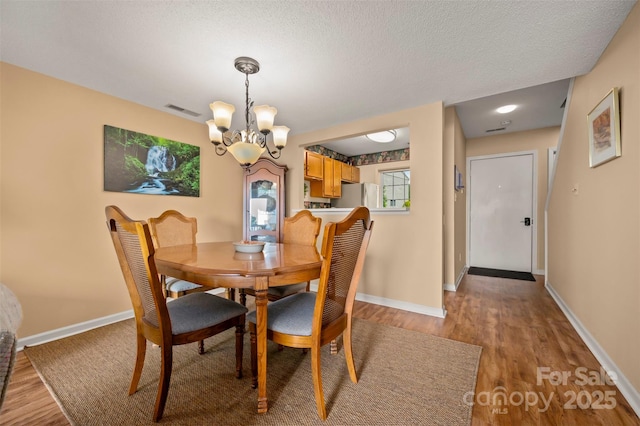 2881 White Oak Mountain Rd Unit D5, Columbus, NC 28722 - dining area featuring light wood-style floors, a chandelier, and a textured ceiling