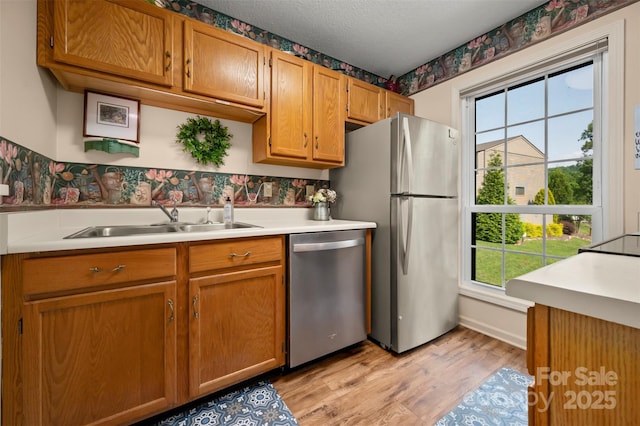 2881 White Oak Mountain Rd Unit D5, Columbus, NC 28722 - kitchen featuring appliances with stainless steel finishes, light countertops, healthy amount of natural light, light wood-type flooring, and a textured ceiling