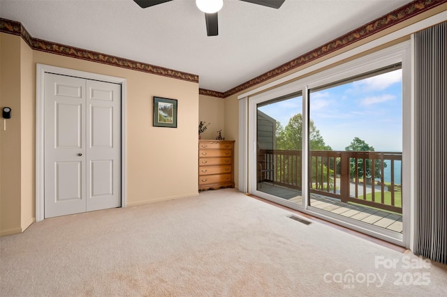 2881 White Oak Mountain Rd Unit D5, Columbus, NC 28722 - unfurnished bedroom with access to outside, carpet floors, ceiling fan, and a closet