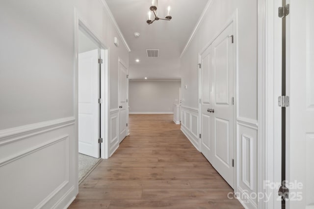 308 Alameda Way, Matthews, NC 28104 - corridor featuring crown molding, light wood finished floors, recessed lighting, a wainscoted wall, and a decorative wall
