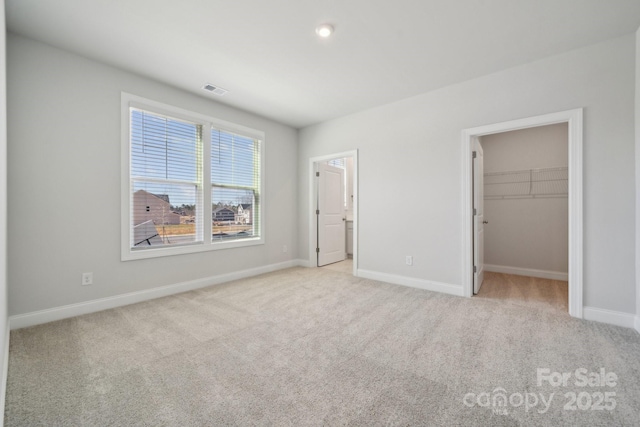 308 Alameda Way, Matthews, NC 28104 - unfurnished bedroom featuring light colored carpet, a spacious closet, and a closet