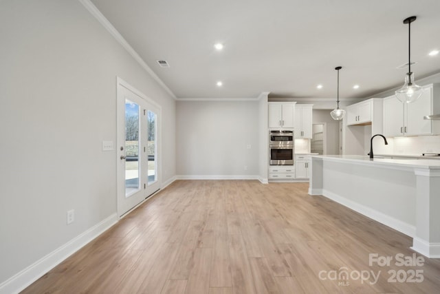 308 Alameda Way, Matthews, NC 28104 - unfurnished living room featuring crown molding, recessed lighting, and light wood-type flooring