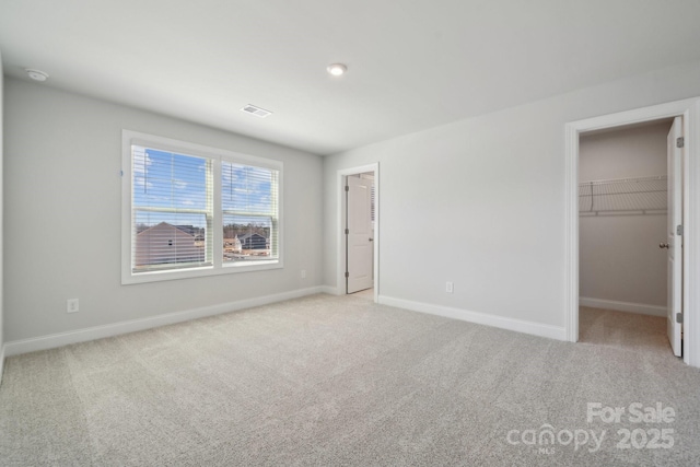 308 Alameda Way, Matthews, NC 28104 - unfurnished bedroom featuring light carpet, a spacious closet, and a closet