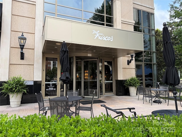 5730 Closeburn Rd Unit N, Charlotte, NC 28210 - view of exterior entry with outdoor dining space, stucco siding, and a patio