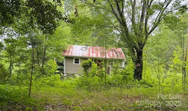 69 Ginger Snap Dr, Nebo, NC 28761 - view of home's exterior featuring a metal roof and a view of trees