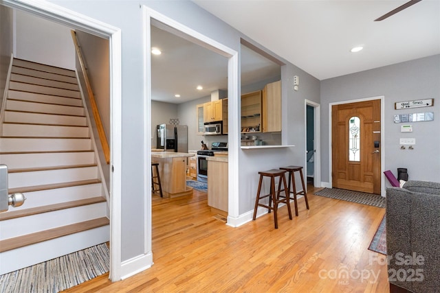 501 Mercury St, Charlotte, NC 28205 - foyer entrance with light wood finished floors, stairway, a ceiling fan, and recessed lighting