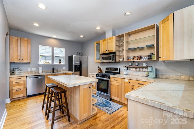 501 Mercury St, Charlotte, NC 28205 - kitchen with stainless steel appliances, a breakfast bar, recessed lighting, a kitchen island, and light wood-style floors