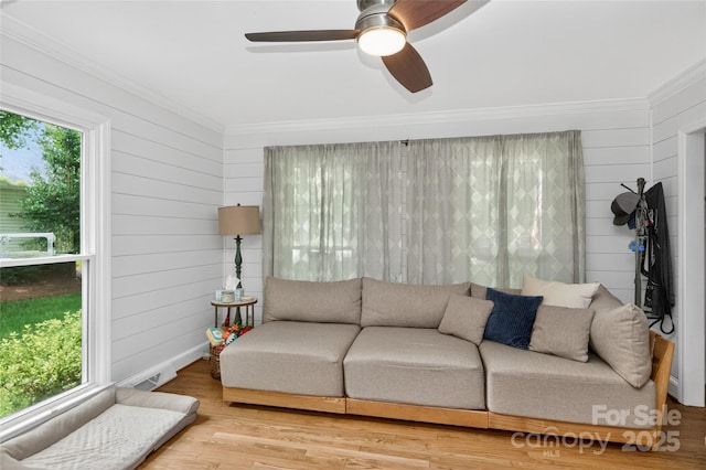 8300 Quarters Ln, Mint Hill, NC 28227 - living room featuring plenty of natural light, crown molding, a ceiling fan, wood finished floors, and wooden walls