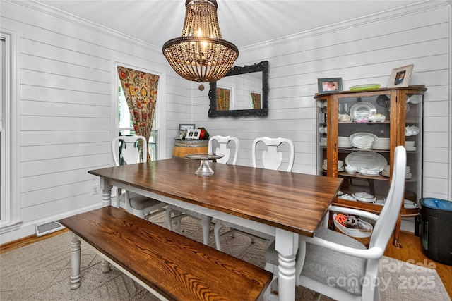 8300 Quarters Ln, Mint Hill, NC 28227 - dining space with ornamental molding, a chandelier, wood finished floors, and wood walls
