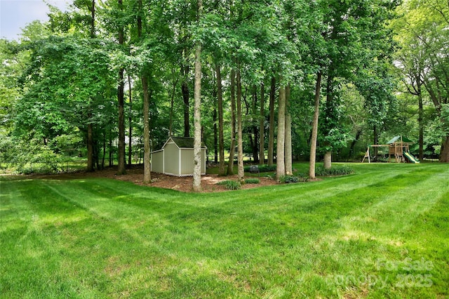 8300 Quarters Ln, Mint Hill, NC 28227 - view of grassy yard with a storage unit and a playground