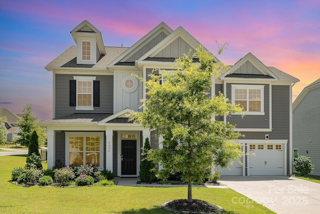8420 Golden Stone Ln Unit 138, Fort Mill, SC 29707 - view of front of house with board and batten siding, an attached garage, concrete driveway, a front lawn, and roof with shingles