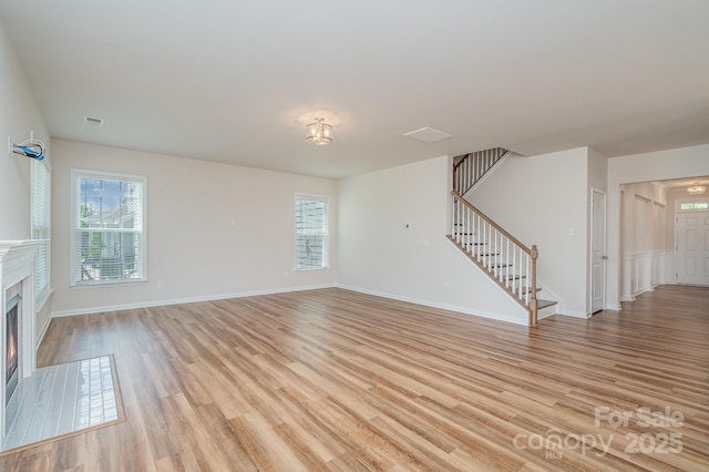 8420 Golden Stone Ln Unit 138, Fort Mill, SC 29707 - unfurnished living room featuring stairway, healthy amount of natural light, and light wood-type flooring