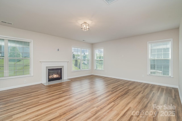 8420 Golden Stone Ln Unit 138, Fort Mill, SC 29707 - unfurnished living room featuring light wood-type flooring and a fireplace with flush hearth