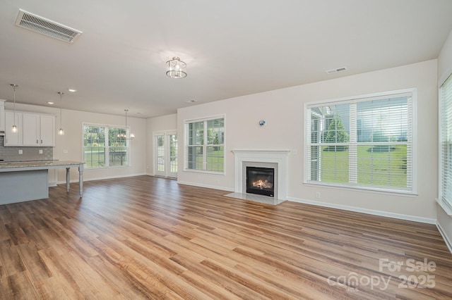 8420 Golden Stone Ln Unit 138, Fort Mill, SC 29707 - unfurnished living room featuring light wood finished floors, a fireplace with flush hearth, and recessed lighting
