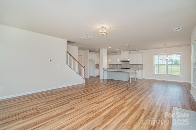 8420 Golden Stone Ln Unit 138, Fort Mill, SC 29707 - unfurnished living room with a chandelier, light wood-style floors, stairway, and recessed lighting