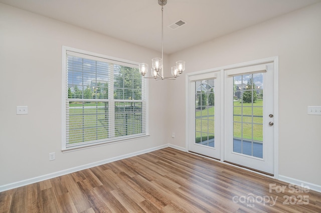 8420 Golden Stone Ln Unit 138, Fort Mill, SC 29707 - unfurnished dining area with a chandelier, wood finished floors, and healthy amount of natural light