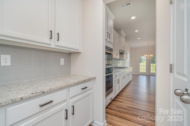 8420 Golden Stone Ln Unit 138, Fort Mill, SC 29707 - kitchen featuring appliances with stainless steel finishes, tasteful backsplash, white cabinets, light wood finished floors, and recessed lighting