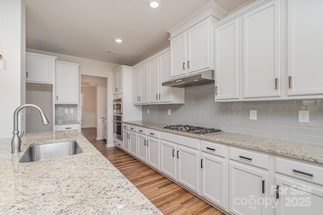 8420 Golden Stone Ln Unit 138, Fort Mill, SC 29707 - kitchen featuring stainless steel gas cooktop, white cabinetry, light wood-style floors, backsplash, and recessed lighting