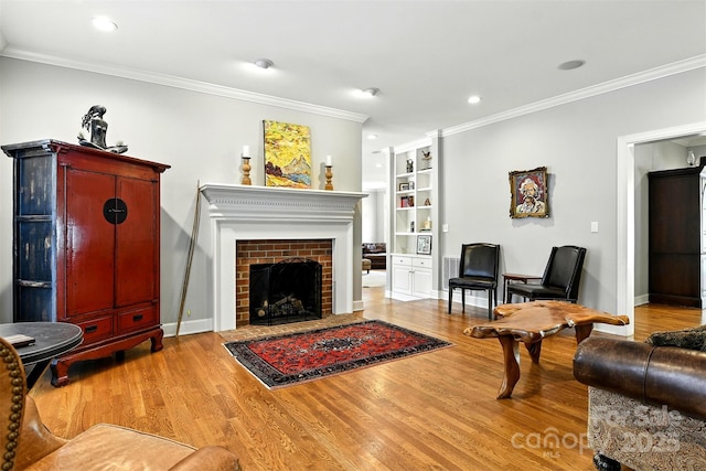 1009 13th Avenue Pl NW Unit 19, Hickory, NC 28601 - living area with crown molding, wood finished floors, a fireplace, recessed lighting, and built in shelves
