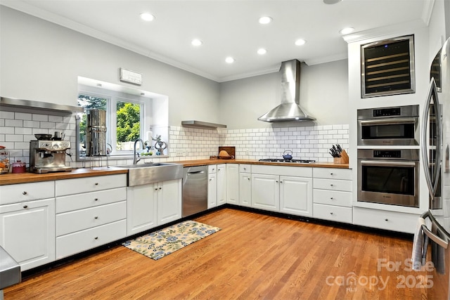 1009 13th Avenue Pl NW Unit 19, Hickory, NC 28601 - kitchen with wooden counters, wall chimney exhaust hood, stainless steel appliances, ornamental molding, and recessed lighting