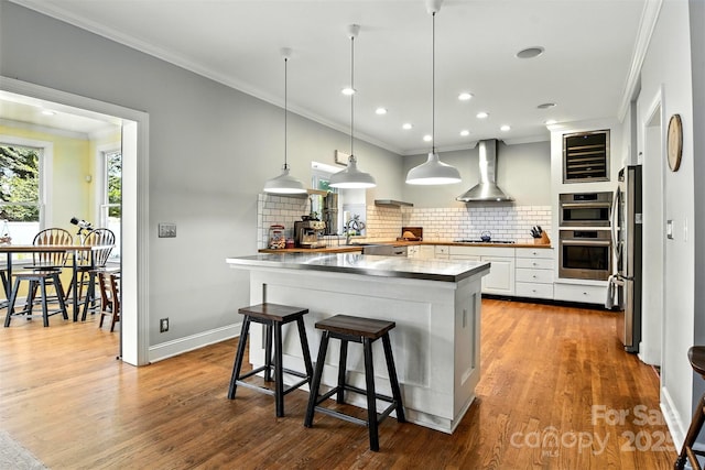 1009 13th Avenue Pl NW Unit 19, Hickory, NC 28601 - kitchen with wall chimney range hood, crown molding, stainless steel appliances, backsplash, and white cabinets