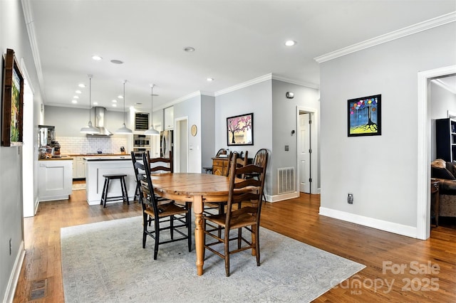1009 13th Avenue Pl NW Unit 19, Hickory, NC 28601 - dining space with wood finished floors, ornamental molding, and recessed lighting