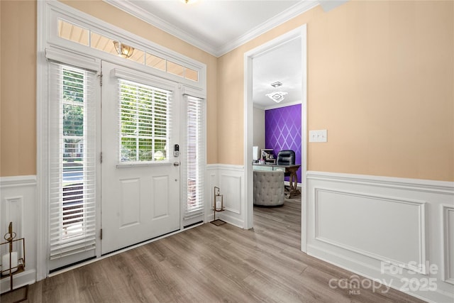 1152 Mckee Farm Ln, Belmont, NC 28012 - entryway with crown molding, a wainscoted wall, a decorative wall, and light wood-style flooring