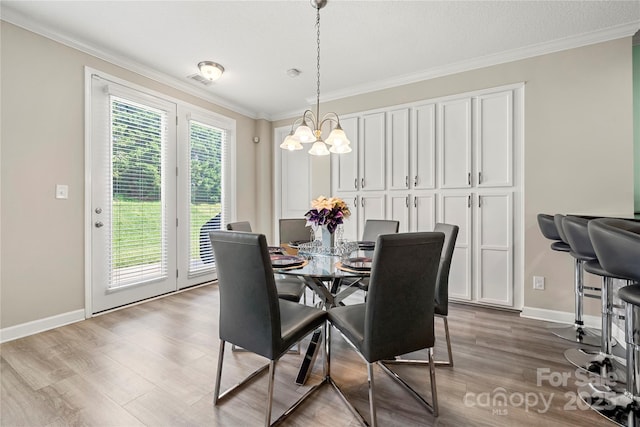 1152 Mckee Farm Ln, Belmont, NC 28012 - dining space with a chandelier, ornamental molding, and wood finished floors