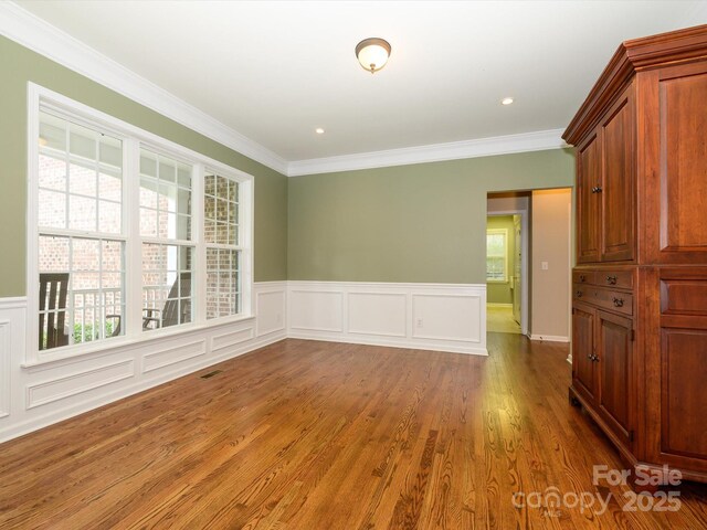 9212 John Hawks Rd, Cornelius, NC 28031 - unfurnished room with ornamental molding, a wainscoted wall, wood finished floors, and a decorative wall