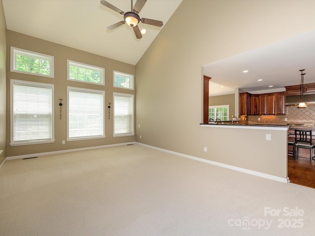 9212 John Hawks Rd, Cornelius, NC 28031 - unfurnished living room with carpet, high vaulted ceiling, a ceiling fan, and recessed lighting