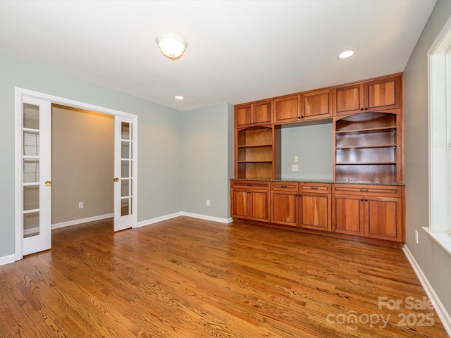 9212 John Hawks Rd, Cornelius, NC 28031 - unfurnished living room with french doors, wood finished floors, and recessed lighting