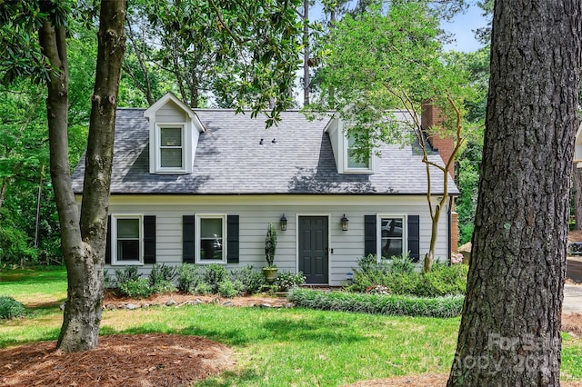 1040 Goshen Pl, Charlotte, NC 28211 - cape cod-style house with a front lawn, a chimney, and a shingled roof