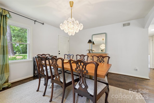 1040 Goshen Pl, Charlotte, NC 28211 - dining room featuring wood finished floors, arched walkways, and a chandelier
