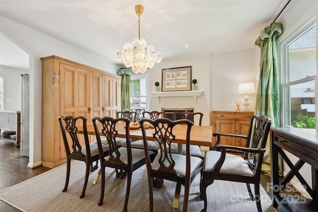 1040 Goshen Pl, Charlotte, NC 28211 - dining room with arched walkways, dark wood-style flooring, and a chandelier