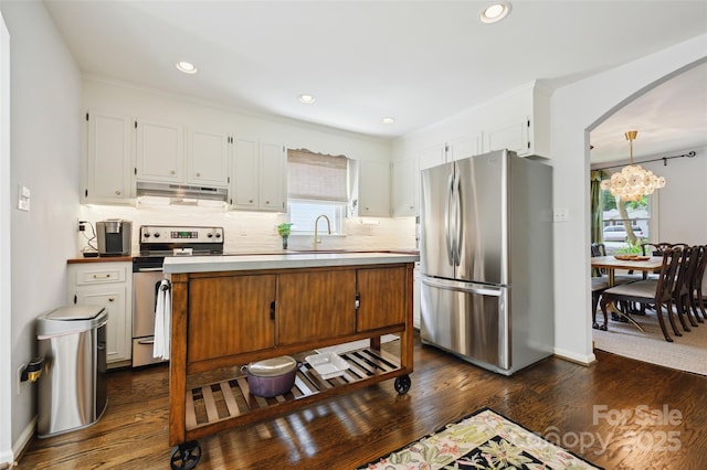 1040 Goshen Pl, Charlotte, NC 28211 - kitchen with appliances with stainless steel finishes, under cabinet range hood, backsplash, dark wood-style floors, and recessed lighting