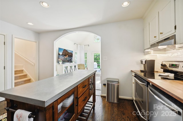 1040 Goshen Pl, Charlotte, NC 28211 - kitchen with under cabinet range hood, stainless steel appliances, dark wood finished floors, recessed lighting, and white cabinetry