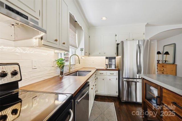 1040 Goshen Pl, Charlotte, NC 28211 - kitchen with stainless steel appliances, range hood, dark wood-style floors, white cabinetry, and decorative backsplash