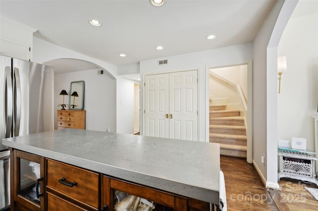 1040 Goshen Pl, Charlotte, NC 28211 - kitchen featuring arched walkways, dark wood-style flooring, freestanding refrigerator, recessed lighting, and a kitchen island