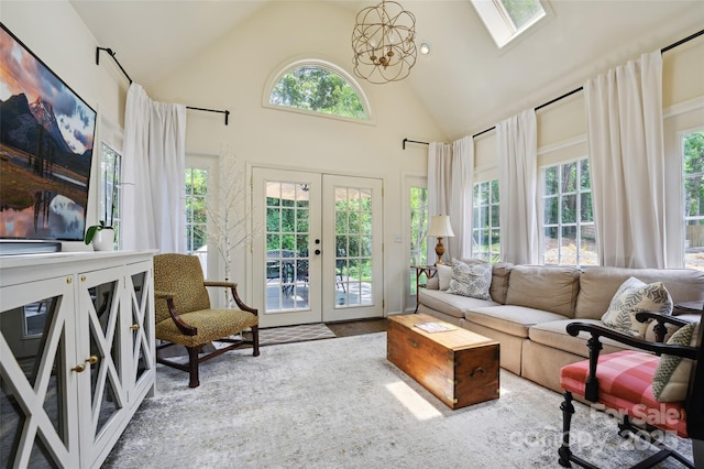 1040 Goshen Pl, Charlotte, NC 28211 - living room with high vaulted ceiling, french doors, a skylight, and a chandelier