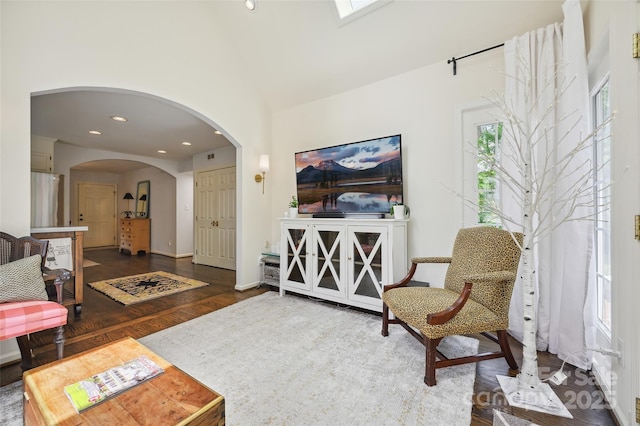 1040 Goshen Pl, Charlotte, NC 28211 - living room featuring wood finished floors, arched walkways, recessed lighting, and high vaulted ceiling