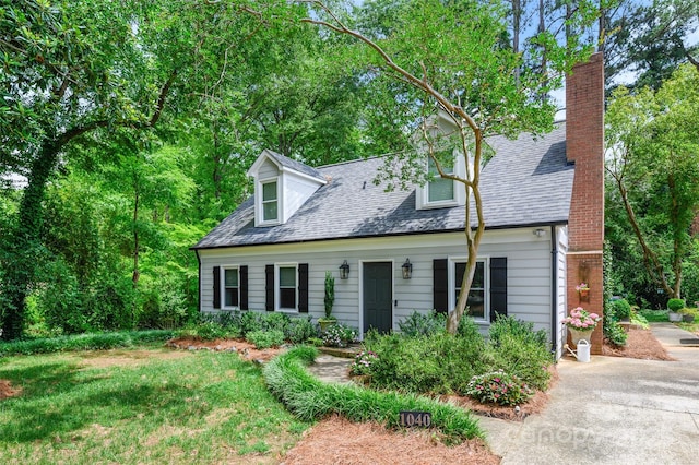 1040 Goshen Pl, Charlotte, NC 28211 - cape cod home featuring a chimney, roof with shingles, and driveway