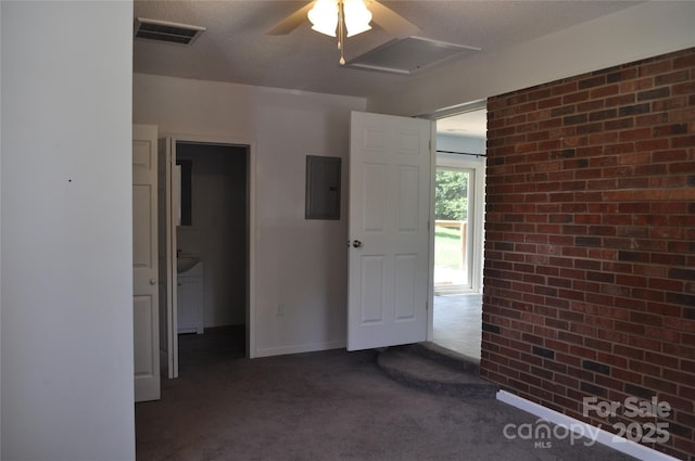 125 Heritage View Rd, Hickory, NC 28601 - unfurnished bedroom with electric panel, dark colored carpet, brick wall, and ceiling fan