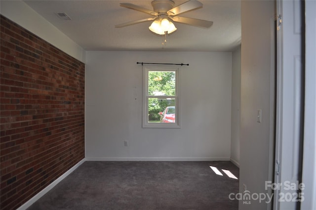 125 Heritage View Rd, Hickory, NC 28601 - unfurnished room featuring brick wall, dark colored carpet, and ceiling fan