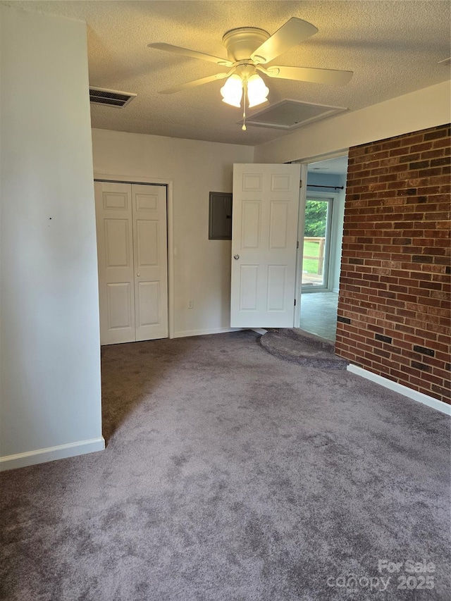 125 Heritage View Rd, Hickory, NC 28601 - unfurnished bedroom with brick wall, a closet, a textured ceiling, carpet floors, and ceiling fan