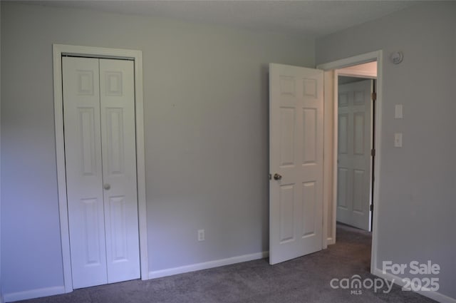 125 Heritage View Rd, Hickory, NC 28601 - unfurnished bedroom featuring dark colored carpet and a closet