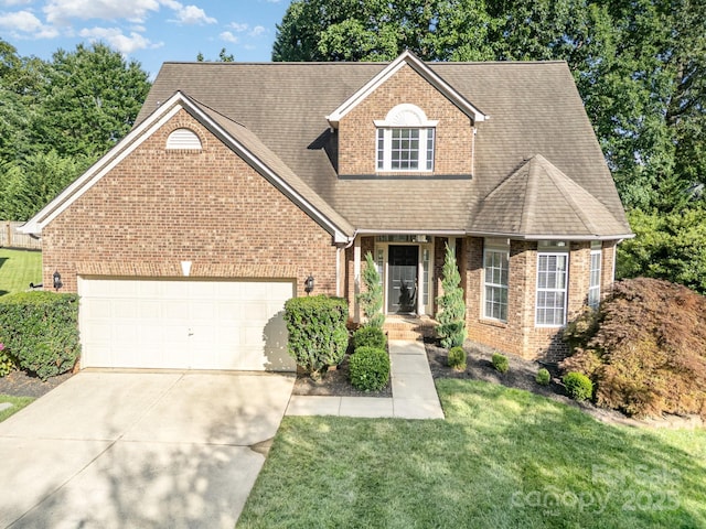 19509 Trintella Ln, Cornelius, NC 28031 - traditional-style house with brick siding, driveway, an attached garage, and a front yard