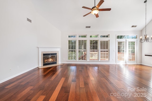 19509 Trintella Ln, Cornelius, NC 28031 - unfurnished living room with a chandelier, ceiling fan, a premium fireplace, vaulted ceiling, and wood finished floors