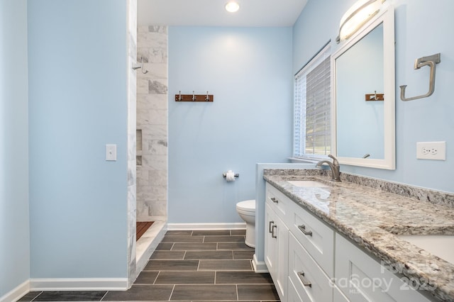 19509 Trintella Ln, Cornelius, NC 28031 - full bathroom featuring double vanity, tiled shower, recessed lighting, and wood finish floors